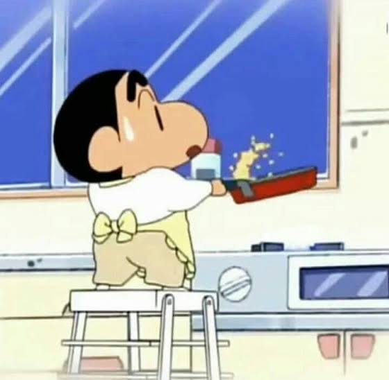 Shin-chan cooking on a step stool
