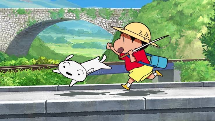 Shin-chan and Shiro running by a mossy bridge